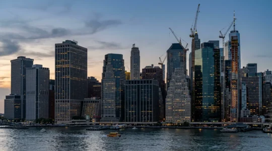 Manhattan office towers undergoing residential conversion with modern construction visible