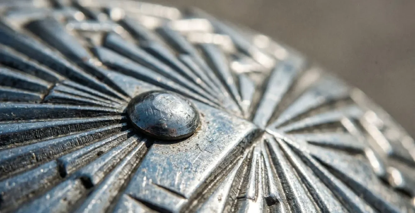 Close-up detail of Nirosta stainless steel architectural element showing ribbed sunburst pattern