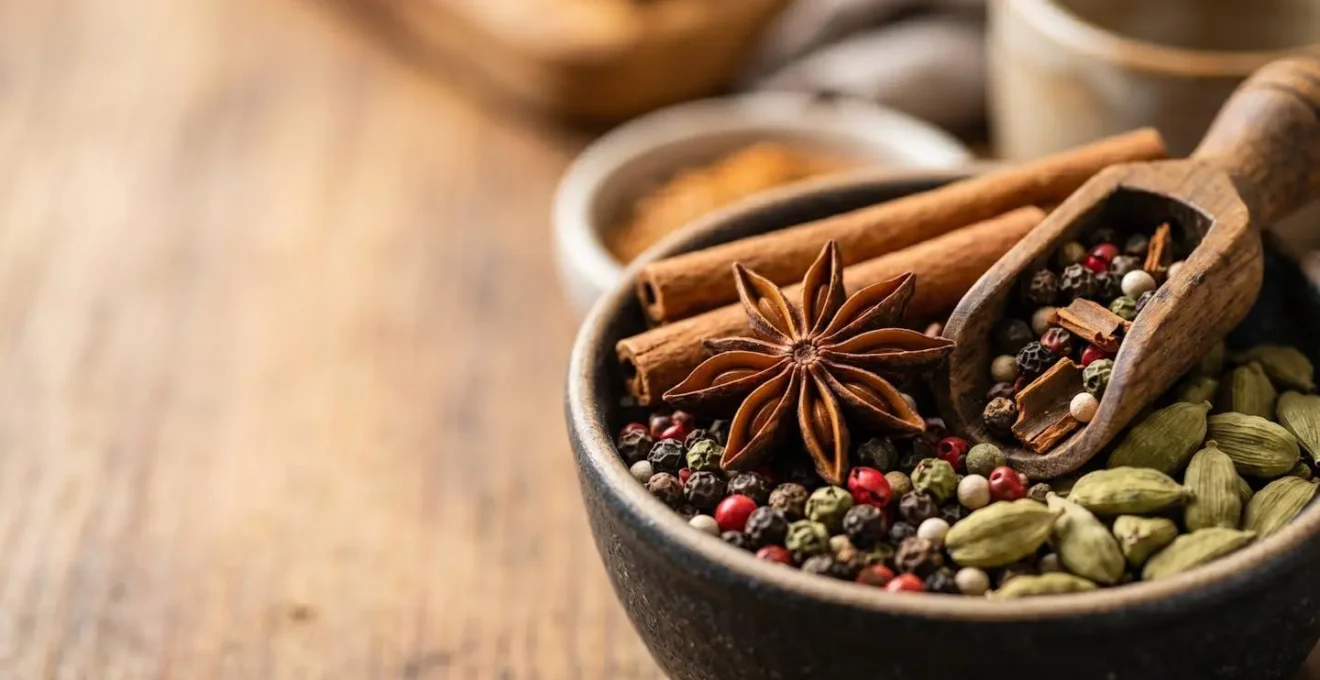Extreme close-up of whole spices in open bulk containers showing rich textures and vibrant natural colors